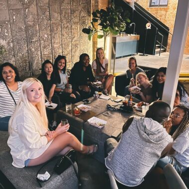 Customers sitting around a table smiling