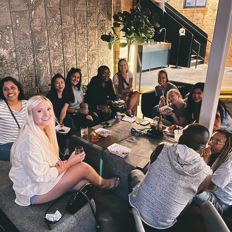 Customers sitting around a table smiling
